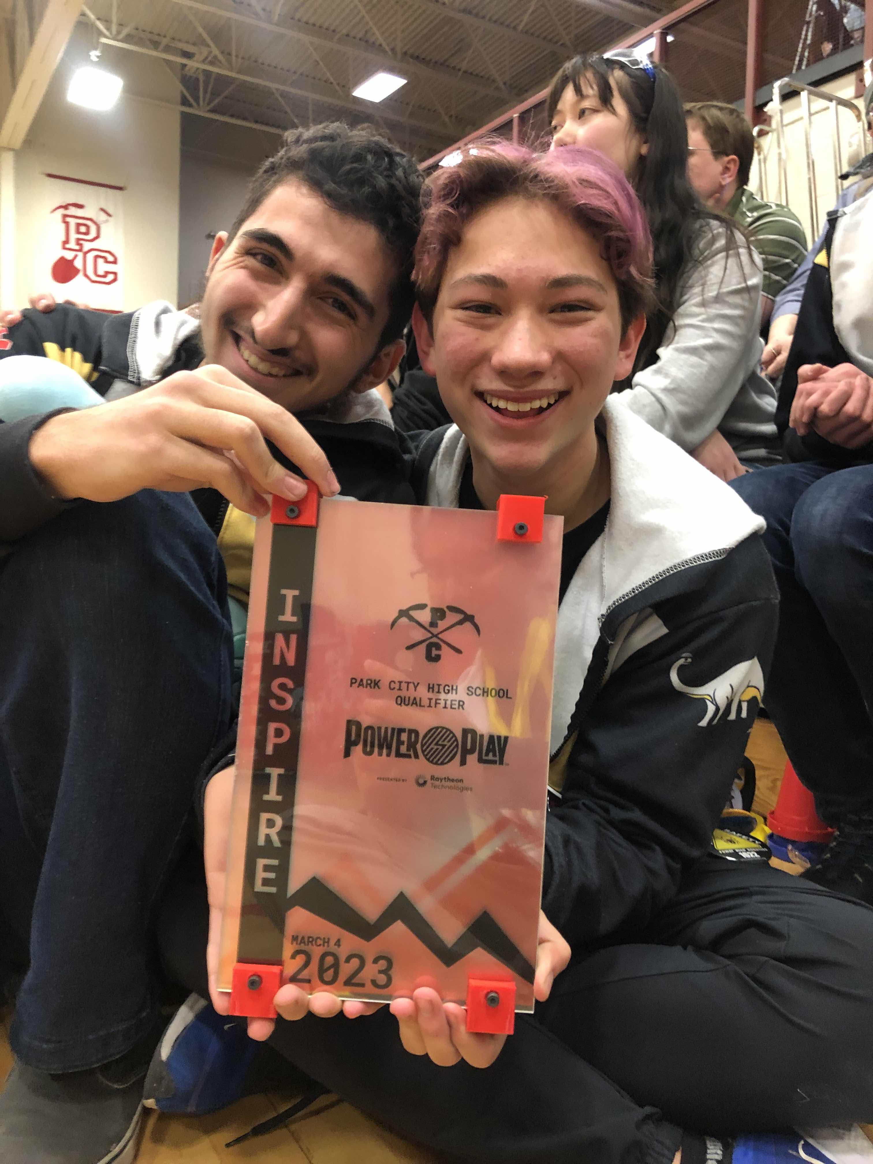 Evan Weinstein and Omar Alsolaiman, holding an Inspire award.